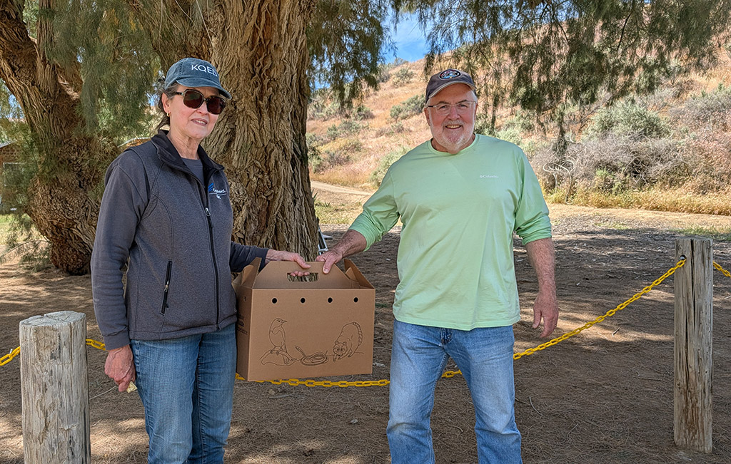 Volunteers, Allison & Kevin holding the box with Chloe inside - March 26, 2026